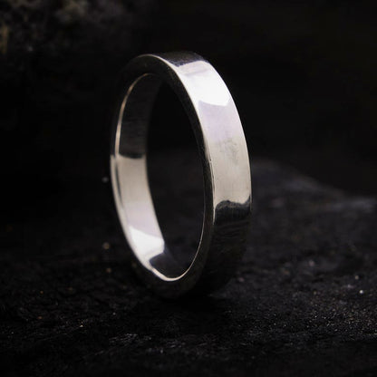 Alianza de boda de sección cuadrada y banda plana en plata brillante.